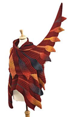 a red and yellow shawl is on a mannequin's dummy head