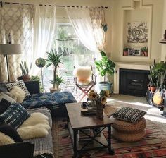 a living room filled with lots of furniture and plants on top of a coffee table