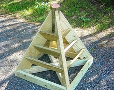 a wooden triangle on the side of a road