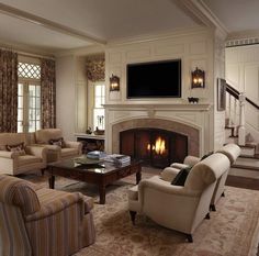 a living room filled with furniture and a fire place in the middle of a room