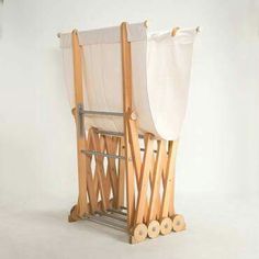 a wooden chair with white fabric on the back and sides, in front of a white background