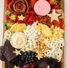 a platter filled with fruit, cheese and crackers