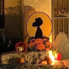 a bathroom decorated for halloween with pumpkins and candles in front of the toilet bowl