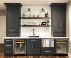 a kitchen with gray cabinets and stainless steel appliances in the center, along with open shelving