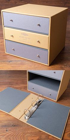 an open file cabinet sitting on top of a wooden floor next to a pair of glasses