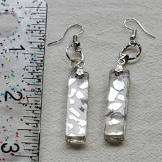 Rectangle-shaped clear resin earrings with silver drop. With mirror chips embedded. Rectangular Clear Earrings For Gift, Stone Studs, Resin Earrings, Clear Resin, Silver Drop Earrings, Rectangle Shape, Jewelry Earrings Dangle, Free Gifts, Dangle Drop Earrings