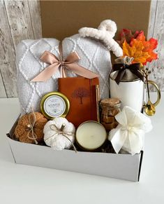 a gift box filled with candles and other items