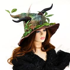 This hand felted Horned Forest Goddess witch hat is ready for a renfaire costume, a festival, a convention, or your table centerpiece. One of a kind, ferns and forest branches are abundant, peeking around the horns, and growing from the base, with two leaves at the tip. A copper encased crystal stone rests at the center of it all. A cloth vine decorates the back. I've worked the curl into the hat, so the style and character are already built in. The quality vinyl leather brim is wired, so you ca Curved Brim Costume Hat For Carnival, Curved Brim Carnival Costume Hat, Curved Brim Hats For Carnival Costume, Halloween Costume Felt Hat, Witchy Costume Hat With Curved Brim For Festivals, Witchy Festival Hat With Curved Brim, Witchy Festival Costume Hat With Curved Brim, Curved Brim Costume Hats For Fall, Curved Brim Costume Hats And Headpieces For Fall