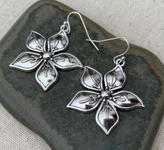 "Shiny, bold and oh so pretty! Big silver flower earrings are eye catching and classic. Dress them up or down. These would make the perfect everyday earrings for any nature lover. The earrings measure 1 1/4\" long by 1 1/4\" wide. They hang from simple silver ear wire hooks. Overall drop length is 1 3/8\". Made from allergy free plated silver. I have a matching necklace in my shop, if you would like the whole set. Here is a direct link https://etsy.me/3wirKEC Thanks for stopping by! Please take Flower Earrings Silver, Flower Statement Earrings, Modern Hoop Earrings, Mountain Earrings, Mountain Jewelry, Silver Flower Earrings, Hammered Hoop Earrings, Earrings Big, Big Hoop Earrings