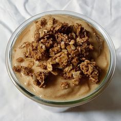 a bowl filled with oatmeal and nuts on top of a white cloth