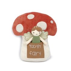 a red mushroom with a little fairy sitting on it's back and the words tooth fairy written in white