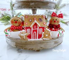 three gingerbread houses are sitting on a platter