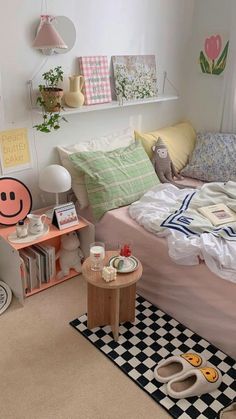 a bed room with a neatly made bed next to a shelf filled with books and other items