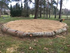 a large sand pit in the middle of a field