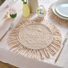 the table is set with white plates and utensils