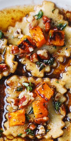 a white plate topped with meat and veggies covered in gravy on top of a wooden table