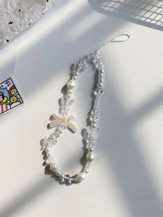 a white necklace and bracelet on top of a table