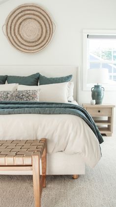 a bedroom with a large bed and white walls