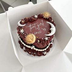 a heart shaped cake in a box with writing on it