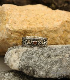 Garnet rock ring in silver, Unique vine wedding ring, Hammered wedding band in vintage style, Wild nature ring, Wide women's wedding ring ■ All wedding rings are only crafted with the finest of recycled metals DETAILS: Stone - 3mm Garnet Metal - Sterling Silver Dimensions - width 8mm (0.31 in.), Thickness - 1,4mm (0.055 in.) Finish - oxidized (shiny at your request) Please choose your ring size and gems in menu while making your order View all rock rings and bands: https://etsy.me/2UlV8Zj ■ CUST Bohemian Rings With Oxidized Finish For Anniversary, Bohemian Antique Silver Wedding Rings, Rustic Silver Wedding Rings, Rustic Silver Promise Ring, Vine Wedding Ring, Hammered Wedding Band, Rock Ring, Garnet Wedding Rings, Rustic Wedding Bands