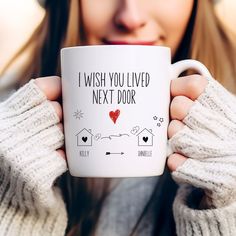 a woman holding a coffee mug that says i wish you lived next door