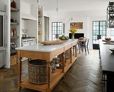 a large kitchen with an island in the middle and lots of counter space on one side