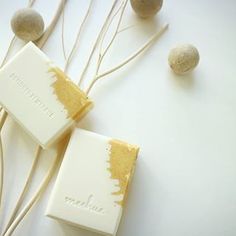 three bars of soap sitting on top of each other next to some rocks and twigs