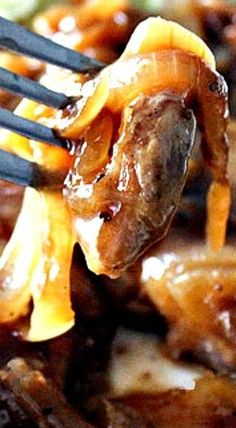 a fork with some food on top of it and sauce being poured over the meat