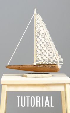 a small wooden sailboat sitting on top of a table