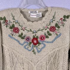 a sweater with flowers and leaves on it