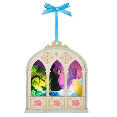 an ornament with stained glass windows and a blue ribbon hanging from it's side