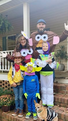 a man and two children standing in front of a turkey costume with a dog on the steps