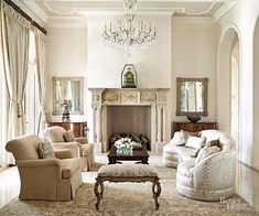 a living room filled with furniture and a chandelier