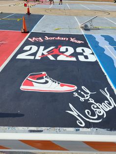 a painted parking lot with shoes on it