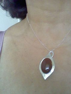 "this beautiful red carnelian is settle on a Silver tear drop hand made with sterling silver, it has a loop that can be used as bail. The stone is 18 x 25 mm and the teardrop is 0.8 mm thick, the chain is 16 inches and 1 mm thick This a special design matches with the carnelian rings that you can see in these links: http://etsy.me/1Tzy0fP http://etsy.me/1TyuVSF *This jewel will be sent to you in a gift box * All the pieces are Hand Made * Custom order We will be glad to make any size, style, oth Carnelian Gemstone Drop Jewelry, Red Carnelian Teardrop Jewelry, Spiritual Teardrop Carnelian Jewelry, Carnelian Gemstone Oval Pendant Jewelry, Carnelian Gemstone Oval Pendant, Silver Carnelian Oval Cabochon Jewelry, Amber Teardrop Cabochon Necklace, Oval Carnelian Jewelry With Natural Stones, Brown Sterling Silver Teardrop Necklace