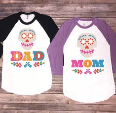 two shirts with the words dad and mom written on them, one has a skull in it