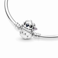 Our classic Pandora Moments bangle gets an update thanks to Disney's much-loved Stitch. The mischievous character from Disney's Lilo & Stitch is biting the ball clasp of this sterling silver bangle (incorporated as part of the clasp). The message "Love at first bite" is engraved on the inside of the bangle. The bangle can be styled with up to 16-18 charms, dangle charms or pendants - it's the perfect home for your Disney x Pandora charm collection. Pandora Bracelet Stitch, Stitch Pandora, Disney Pandora Bracelet, Charms Disney, Pandora Charms Disney, Pandora Bracelet Designs, Love At First Bite, Charms Pandora, Disney Charms