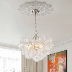 a chandelier hanging from the ceiling in a living room