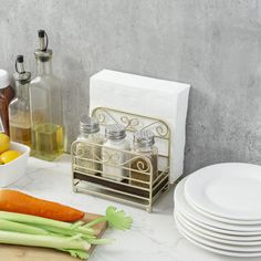 a counter with plates, lemons, carrots and celery on it