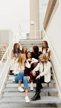 a group of women sitting on top of stairs