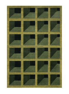 a green area rug with squares and rectangles on the bottom in various shades