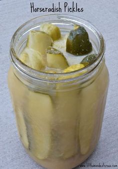 a jar filled with pickles sitting on top of a table