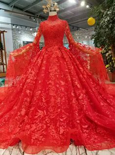 If you want a wedding that is both elegant and traditional, choose the lace red ball gown for your wedding day. Instead of going overboard with different lace patterns, beads and frills, thus dress keeps things simple with a single lace design. Long Sleeve High Neck Wedding Dress, High Neck Long Sleeve Wedding Dress, Wedding Dress With Long Train, Dress With Long Train, Red Ball Gowns, Baju Kahwin, Red Ball Gown, Red Bridal Dress, Red Wedding Dress