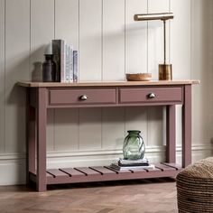 a table with two drawers and a lamp on top