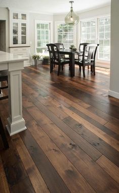 an empty kitchen and dining room with hardwood floors