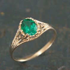 Oval Emerald Ring Filigree 14K Yellow Gold Ring 6 Prong Vintage Style Setting Antique Style Ring May Birthstone Ring Aurora Green Stone Ring To awaken from true loves first kiss, that is what we remember from Sleeping Beauty. Aurora was the princess' name. This beautiful ring emanates with Victorian style elegance and class. The delicate filigree encases the oval Emerald (quality your choice) which is held by 6 prongs. The stunning green stone measures 5mm by 7mm. The ring spans 7.5mm at the wid Yellow Gold Emerald Ring, Luxury Green Oval Engraved Ring, Emerald Gold Ring Vintage, Formal Green 14k Gold Rings, Classic Cluster Ring With Birthstone, Classic Solitaire Ring For May Birthstone, Classic May Birthstone Ring For Formal Occasions, Classic Solitaire Ring With May Birthstone, Classic Sapphire Ring With Prong Setting For May Birthstone