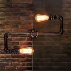 three light bulbs are attached to a metal fixture in front of a brick wall and glass door