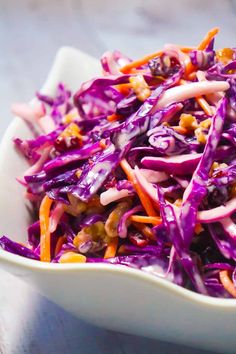 a white plate topped with purple cabbage and nuts