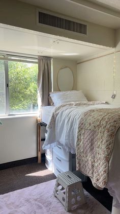 a bedroom with a bed, dresser and window