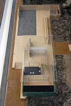 an aerial view of a kitchen and living room in a house with stone walls, flooring and tiled floors